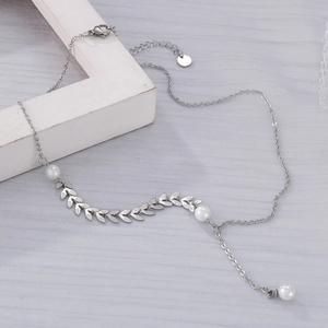 Detail of silver leaf wheat chain necklace with white pearls and Y-shaped drop design