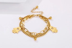 Detail of double-layer gold Hamsa Hand bracelet with beads and Cuban link chain