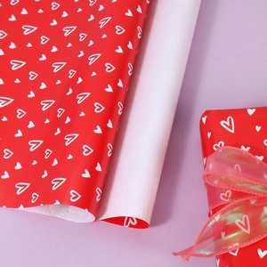 Red heart gift wrapping paper roll with white hand-drawn hearts for Valentine Day gifts