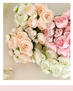 Close-up of realistic artificial mini roses in soft pink, champagne, and white colors