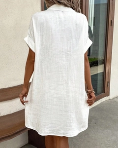 Rear view of white V-neck cotton linen dress with textured fabric and relaxed fit style
