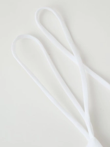 Detail shot of the thin white spaghetti straps on a backless mini dress with lace-up detail