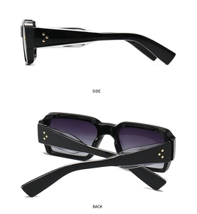 Detail view of black square sunglasses featuring golden star rivets and gradient lenses