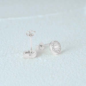 Macro shot of 925 sterling silver halo stud earrings with a large round center diamond