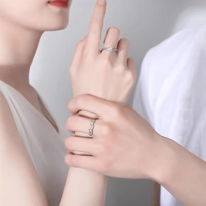 Minimalist Princess and Knight couple rings set worn by a man holding a woman's hand