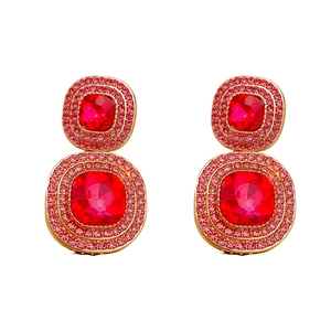 Vintage style gold square drop earrings with pink crystals and rhinestones on white background