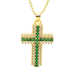 Gold cross pendant necklace with green and white cubic zirconia stones on white background