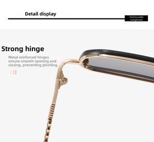 Detail of champagne gold metal reinforced hinges on black frameless ocean sunglasses