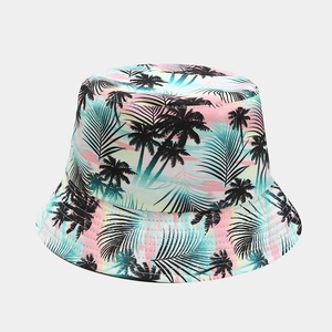 Detail of reversible bucket hat featuring tropical palm tree silhouettes and gradient print
