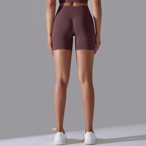 Detail view of high-waist seamless purple fitness shorts with body-shaping elastic fabric