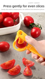 Detail of hand-held tomato slicer cutting small fruits uniformly in a modern kitchen