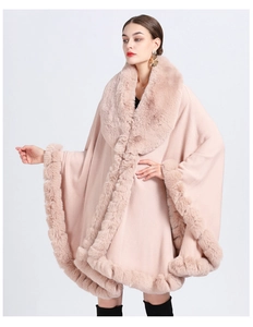 Close-up of pink knit poncho with thick faux rabbit fur collar and plush trim detailing