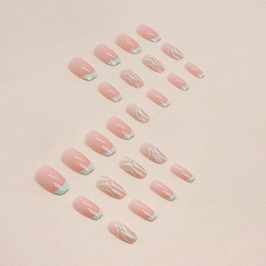Short ballet press-on nails with pink jelly base, blue French tips and white wave patterns