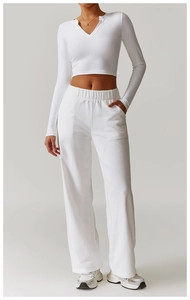 Detail of white slim fit long sleeve yoga top with V-neck and high elastic knit fabric