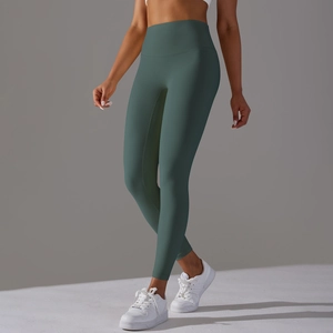 Detail view of high waisted yoga leggings in dark teal showing skin-friendly fabric fit