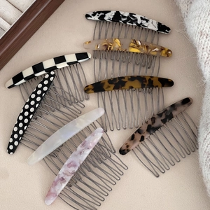 Detail of assorted acetate hair side combs with marble and tortoiseshell patterns