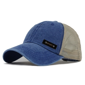 Detail of washed denim blue trucker hat with beige mesh and leather SPORT side patch