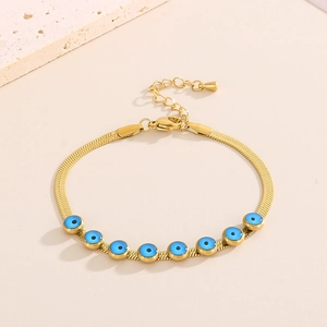 Golden snake chain bracelet with blue evil eye charms and polished finish jewelry