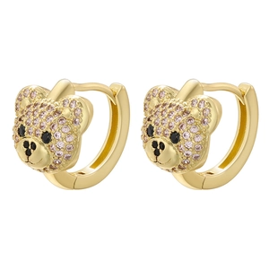 Macro shot of gold-plated teddy bear earrings with pink cubic zirconia and black gems