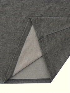 Detail of dark grey knit fabric with black and white striped lining and fine stitching