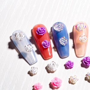 Detailed macro view of 3D resin rose flower nail art charms in various pastel colors