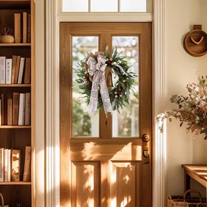 Christmas wreath with pine cones and golden bells on a light wood door home decor