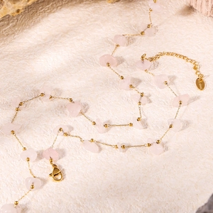 Close-up of pink quartz stones and gold stainless steel chain with lobster clasp detail