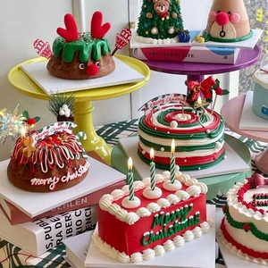 Close-up of Merry Christmas cake toppers and themed cupcakes in festive red and green