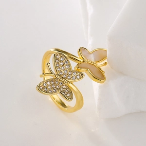 Gold plated butterfly open ring with zircon and mother of pearl on a stone base