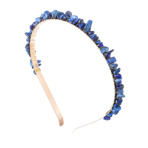Detail view of handmade wire-wrapped blue stone chips on a slim golden headband