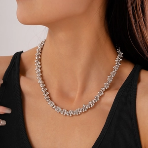 Close-up of vintage silver beaded geometric necklace worn on a black fitted top