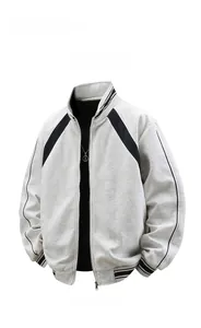 Detail of grey knit jacket showing striped ribbed collar and metal zipper texture