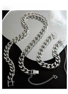 Polished silver curb chain jewelry set with a focus on the secure box clasp detail