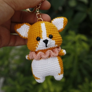 Handmade crochet Corgi puppy keychain with orange and white yarn and golden clasp
