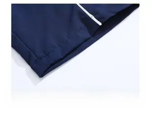 Close-up of navy casual trousers showing white contrast piping and neat stitching