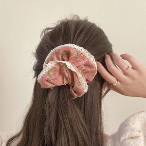 French vintage floral corduroy scrunchie with white lace trim shown on model
