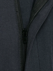 Macro detail of high-quality metal zipper on durable dark grey twill wide-leg trousers