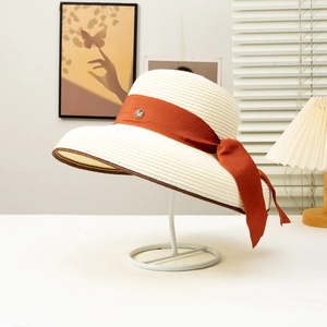 Elegant French vintage wide brim straw sun hat with orange ribbon bow for beach vacations