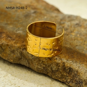 Detailed view of wide 18k gold irregular textured ring with dimensions on stone
