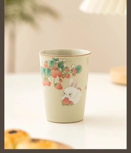 Detail of Ru Kiln ceramic tea cup featuring cute rabbit strawberry and ice-crack glaze
