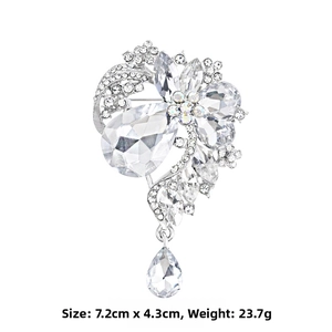 Detail of luxury crystal flower brooch with silver metal base and pear-shaped drop pendant