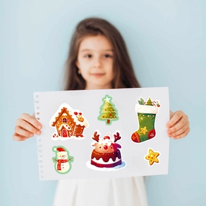 Detail showing various Christmas stickers including gingerbread house and reindeer patterns