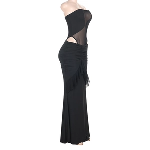 Side view of black mesh cutout maxi dress with ruffled hem and sheer paneling details