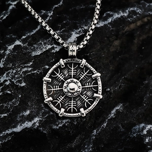 Nordic Viking Vegvisir compass pendant necklace on textured rock with silver box chain