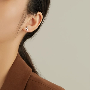 Sterling silver horse stud earring worn on model, showing elegant minimalist animal design