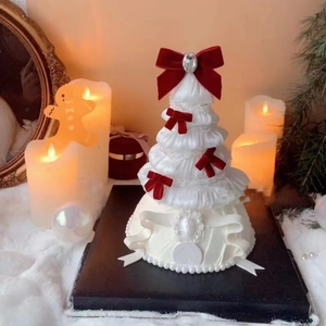 Detail of Christmas tree cake with red bows and white pearls for festive decoration