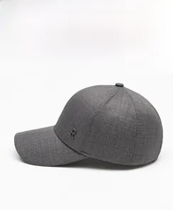 Detail shot of a dark grey baseball cap showing textured fabric and a metal R logo