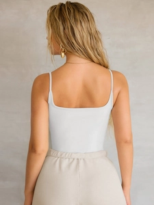 Detailed back view of a white slim-fit strap tank top showing the sleek Y2K racerback design
