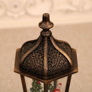 Close-up of vintage bronze Christmas lantern with ornate hollow-out carved top and ring
