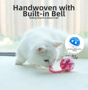 Detail view of pink and white woven cat toy ball with an internal blue bell feature